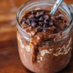 Delicious brownie batter overnight protein oats topped with chocolate and nuts