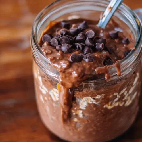 Delicious brownie batter overnight protein oats topped with chocolate and nuts