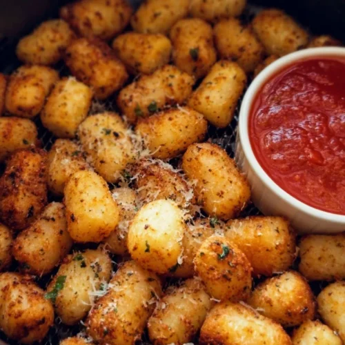Crispy air fryer gnocchi served with herbs and dipping sauce