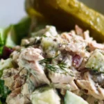Delicious Dill Pickle Chicken Salad in a bowl, garnished with fresh herbs