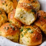 Freshly baked Garlic Bread Rolls served on a rustic wooden table