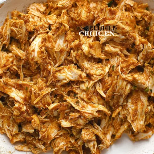 A close-up of savory shredded chicken appetizers arranged on a platter.