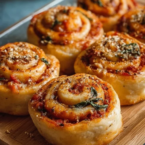 A plate of delicious vegan pizza rolls served with dipping sauce.