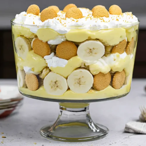 A visually appealing banana pudding trifle with distinct layers of pudding, bananas, and wafers