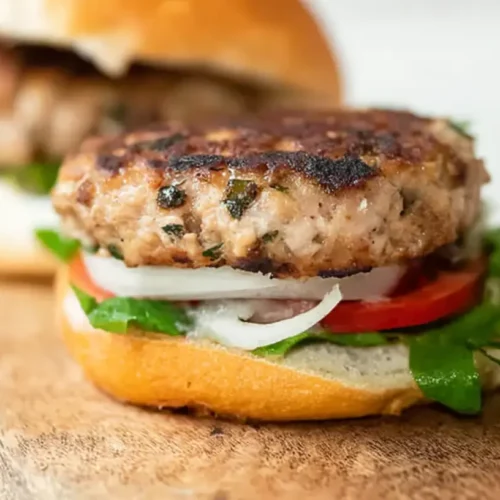 A delicious turkey burger patty, perfectly seared on a grill