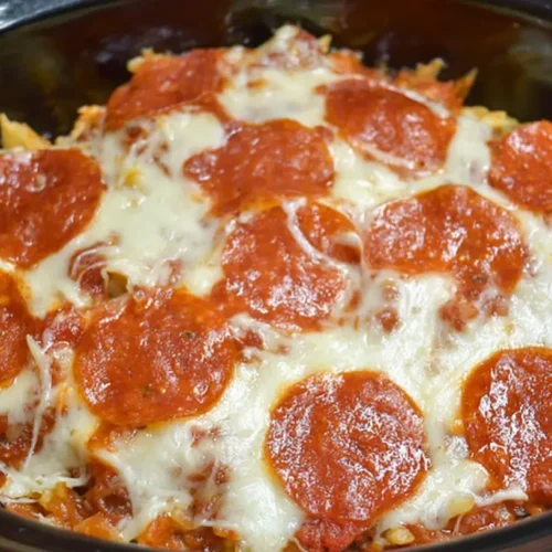A bubbling crockpot pizza casserole ready to serve