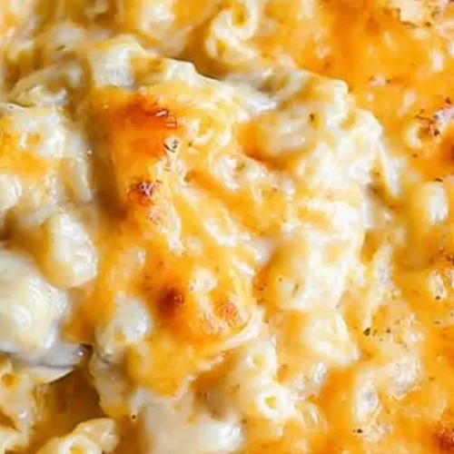 A baking dish filled with a creamy, golden-brown mac and cheese recipe.