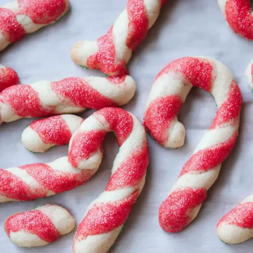 A plate with beautifully swirled red and white candy cane cookies, ready for the holidays.