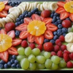 A vibrant fruit platter design featuring an array of colorful cut fruits arranged artfully for kids' parties.
