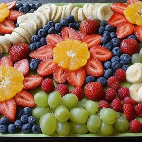 A vibrant fruit platter design featuring an array of colorful cut fruits arranged artfully for kids' parties.