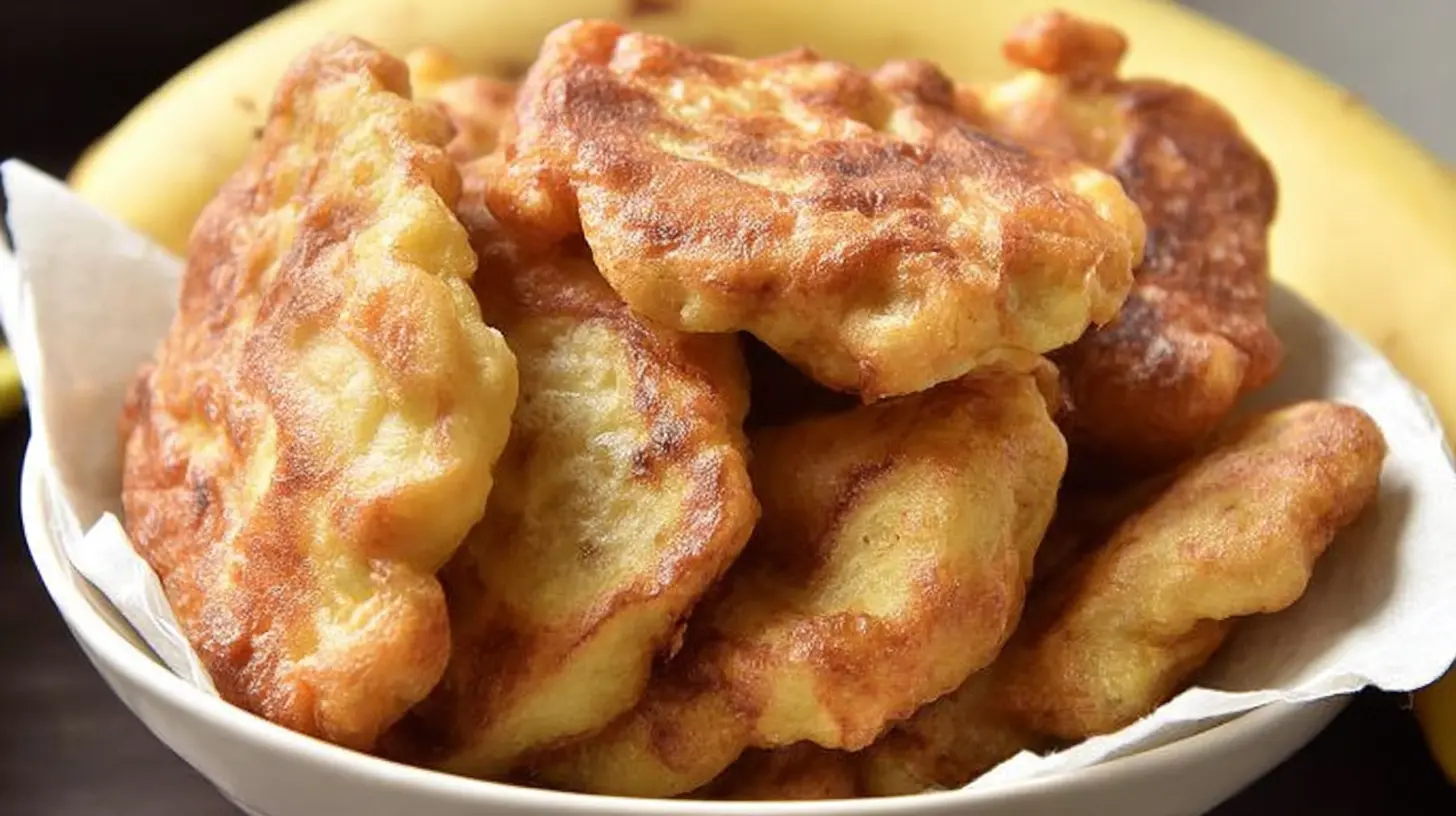 Deliciously fried banana fritters on a clean white dish.