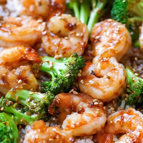 A vibrant honey garlic shrimp bowl served with fresh vegetables and rice.