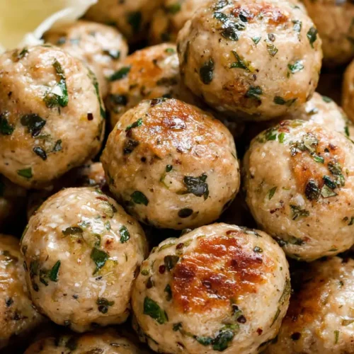 A serving of savory chicken meatballs, perfectly browned.