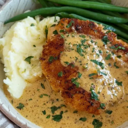 An overhead shot of a simple dinner with chicken and vegetables on a plate