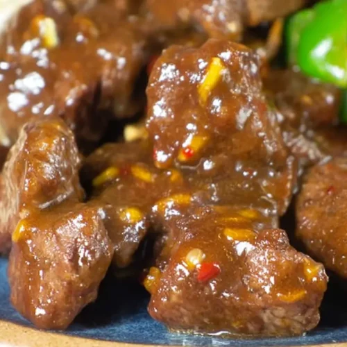 Close-up of perfectly cooked sticky steak bites, glistening with sauce