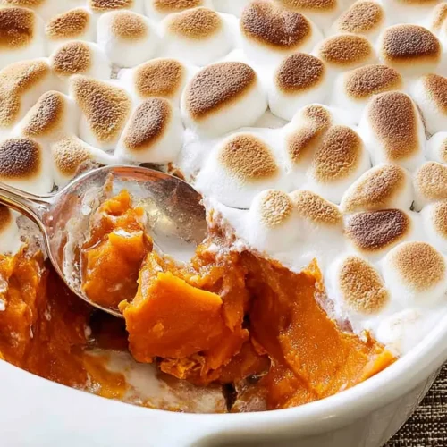 Sweet potatoes with melted marshmallows in a baking dish