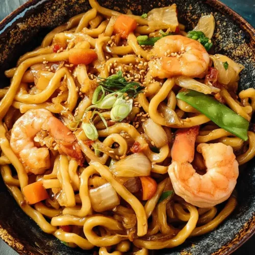 A vibrant dish of Yaki Udon featuring perfectly cooked shrimp and fresh vegetables.