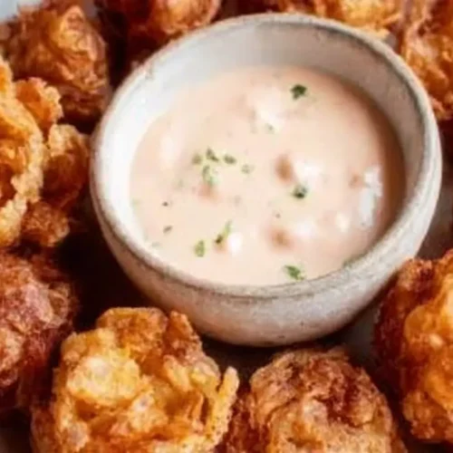 A platter of bite-sized blooming onions served with creamy buttermilk ranch dip.