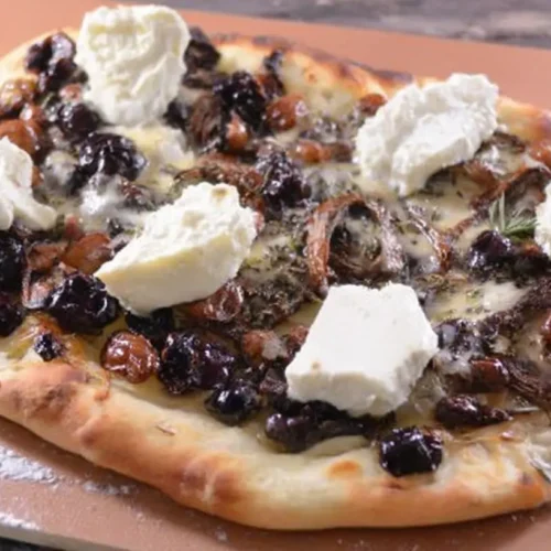 A freshly baked blueberry brie thyme flatbread, hot and ready to serve.