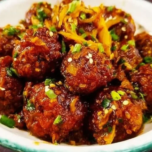 A close-up of delicious Cabbage Manchurian garnished with spring onions