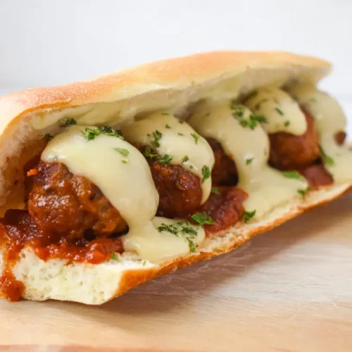 Delicious cheesy meatball subs with melted mozzarella and marinara sauce