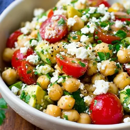 A refreshing Chickpea Feta Avocado Salad in a white bowl