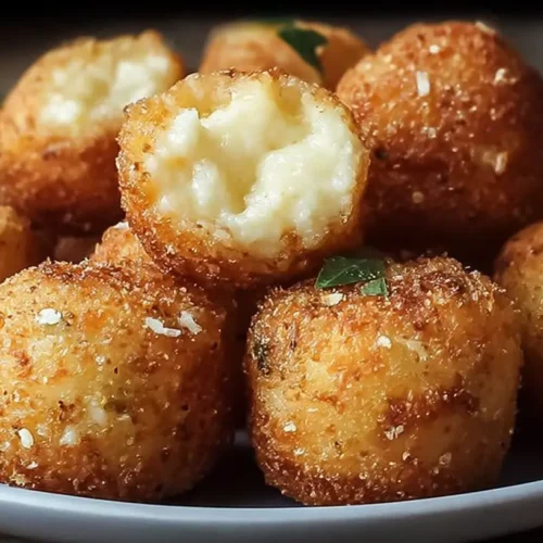 Golden brown crispy mashed potato cheese bites, fresh out of the oven