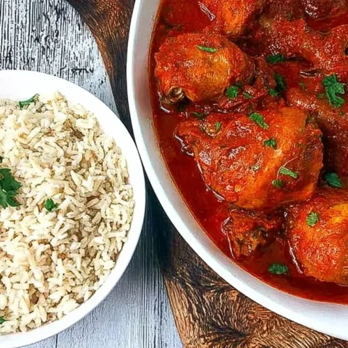 A vibrant bowl of Nigerian Chicken Stew, richly colored and steaming.