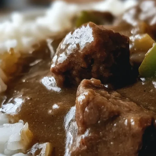 A steaming bowl of Pioneer Woman Beef Tips And Gravy ready to be served over noodles.
