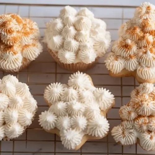 A close-up of smooth, white powdered sugar frosting in a mixing bowl.