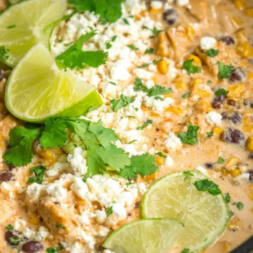 A bowl of slow cooker street corn chicken garnished with cilantro