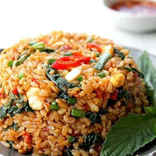 A vibrant plate of Thai fried rice with mixed vegetables and shrimp