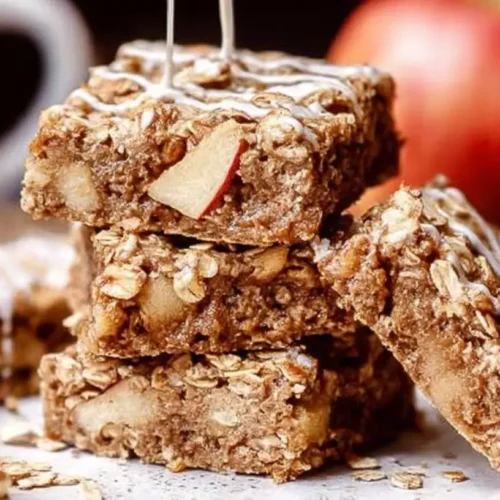 A bowl of warm oatmeal apple breakfast garnished with cinnamon.