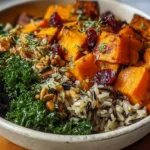 Delicious hearty wild rice bowl featuring roasted sweet potatoes and sautéed kale.