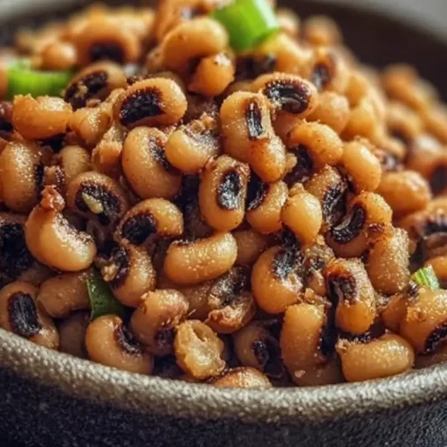 A close-up of crispy air fryer black eyed peas in a bowl, perfectly golden brown