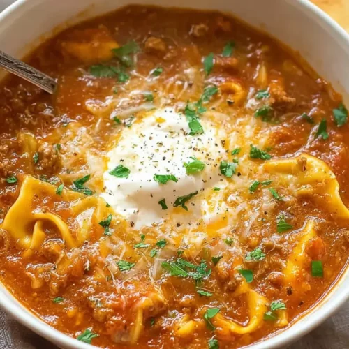 A steaming bowl of hearty lasagna soup, rich with noodles and cheese.