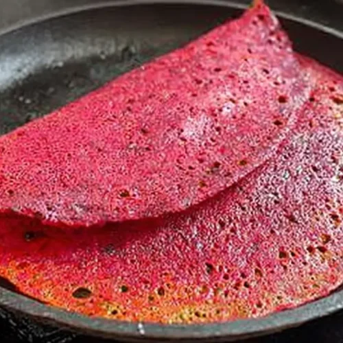 Instant crispy beetroot dosa recipe with a vibrant pink color, served perhaps with chutney.
