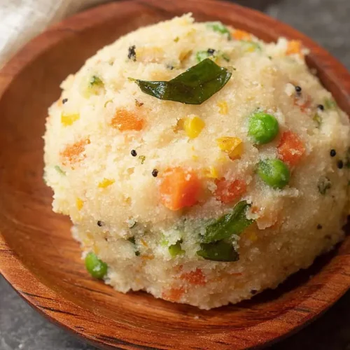 A bowl of freshly cooked vegetable upma, rich with colorful veggies