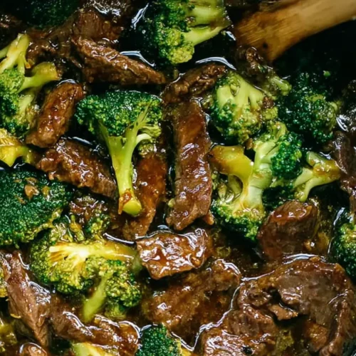 A slow-cooked crockpot beef and broccoli dish, ready to serve over rice.
