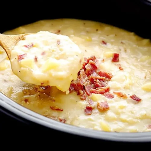A creamy Crockpot potato soup simmering in a slow cooker.