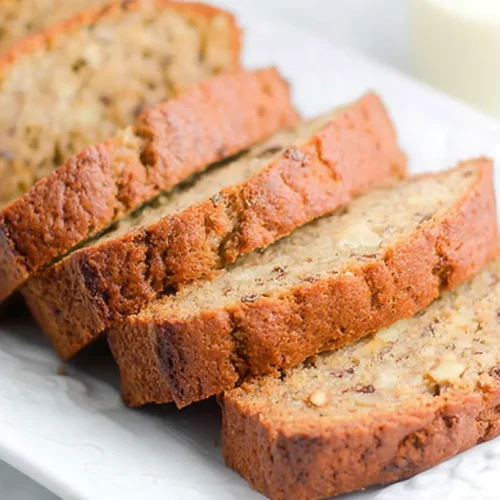 A freshly baked loaf of easy banana bread, golden brown and perfectly sliced.