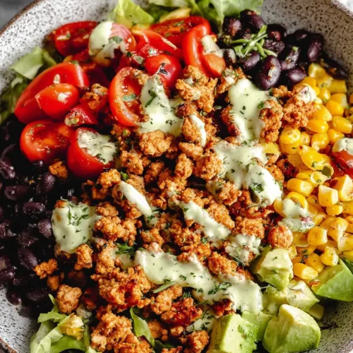 A healthy dinner recipe with ground turkey, featuring colorful vegetables and herbs.