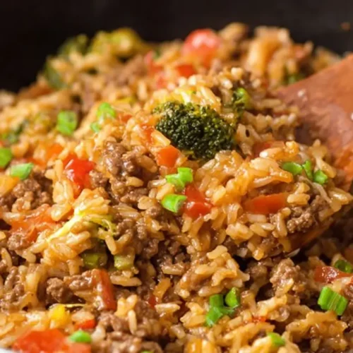 A hearty one-pan ground beef and rice dish, cooked to perfection with vegetables.