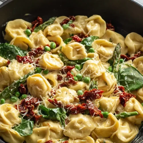 Tuscan tortellini bathed in a rich, creamy sauce with vibrant sun-dried tomatoes.
