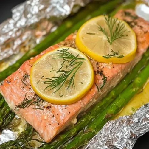 A serving of easy foil baked salmon, perfectly cooked and glistening.