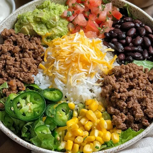 A colorful and hearty Easy Ground Beef Burrito Bowl with various toppings.