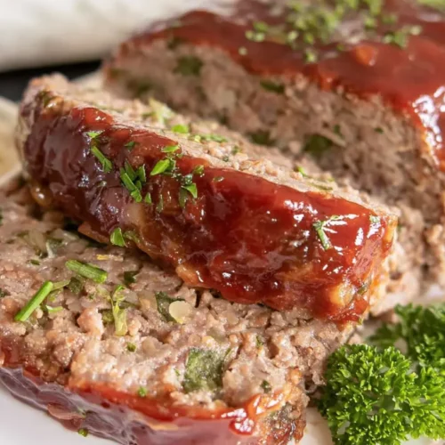 A freshly baked easy homestyle meatloaf on a serving platter.