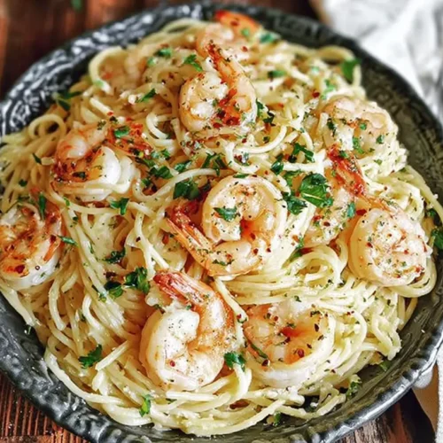 A bowl of easy shrimp pasta with a savory sauce and fresh herbs.