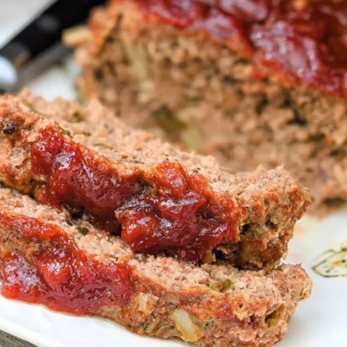 A freshly baked Grandma’s classic meatloaf, sliced and ready to serve.