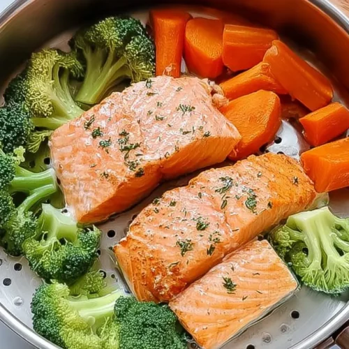 A plate featuring a perfectly cooked salmon fillet alongside a colorful medley of steamed vegetables.